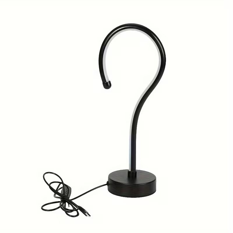 Black curved lamp with base on a white background